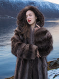 Canadian Raccoon Fur Coat - Silver Tips M with hood, worn by model near icy lake and snowy mountains. Luxurious full-length winter outerwear.