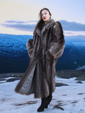 High End Canadian Raccoon Fur Coat with voluminous sleeves, displayed in snowy mountain landscape, ideal for elegant winter fashion.
