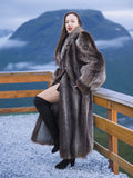 High End Canadian Raccoon Fur Coat in silver tips, full-length, worn outdoors with mountain view, luxury winter outerwear for women.