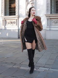 Model in motion wearing vintage pastel Canadian brown mink fur coat over black dress, ideal for bold and elegant winter fashion.