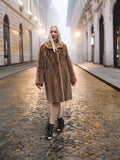 Classic pastel brown mink fur coat stroller jacket M/L styled on cobbled street at dusk. Warm and stylish fur outerwear for winter.