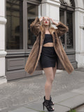 Classic pastel brown mink fur coat stroller jacket M/L styled with black mini dress and heels in urban setting. Luxurious natural fur outerwear.