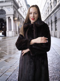 Model in La Galleria mahogany mink fur coat with tie closure, styled in a city setting for sophisticated winter outerwear fashion.