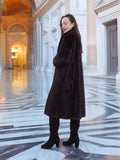 La Galleria full-length mahogany mink fur coat with tie-neck detail, styled in a marble hallway for timeless winter elegance.