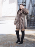 Model posing in Two Tone Mink Fur Jacket L/XL 16 with elegant fur sleeves and soft satin interior lining.