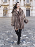 Model walking in Two Tone Herring Bone Mink Fur Jacket L/XL 16, highlighting its voluminous cut and premium fur texture.