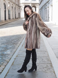 Side view of Canadian Mink Fur Jacket L/XL 16 with soft herring bone design, worn with black boots for a chic winter look.