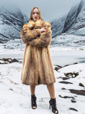 Model in vintage red fox coat in snowy mountains