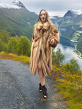 Model in vintage red fox coat overlooking a valley