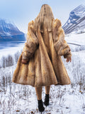 Back view of vintage red fox coat in snowy mountains