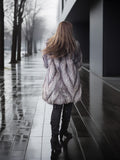 Person walking away in a textured coat on a wet sidewalk