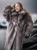 Woman wearing a fur coat with a mountainous landscape in the background