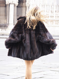 Back view of Unisex Dark Mahogany Mink Fur Bomber Jacket Coat M/L highlighting glossy mink pelts and voluminous silhouette in motion.