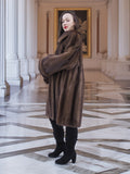 Model posing in Brand New Luxurious Demi Buff Swing Canadian Mink Fur Coat L/XL, styled in a grand hall with classical artwork.