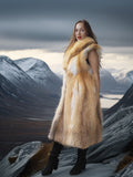 Woman wearing a fur coat standing in a mountainous landscape