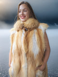 Woman wearing a fur vest with a blurred background