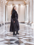 Model twirls in black mink coat, revealing inner lining and dramatic sweep, perfect for luxury winter fashion collections.