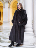 Full-length black mink fur coat with voluminous sleeves, styled against neoclassical architecture for a timeless luxury outerwear look.