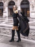 NAFA female black mink coat with indigo fox sleeves and collar in L/XL, styled over a black mini dress and knee-high boots for a chic urban look.
