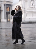 Luxurious black mink coat with silver fox collar in L/XL, shown in side profile highlighting plush fur texture and full-length design.