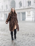 Vintage mink fur coat in rich brown, styled with black boots for a sophisticated outerwear look in urban fashion.