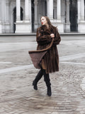 Vintage mink fur coat in dark mahogany brown styled with black boots, showcasing luxurious outerwear for women in size S/M.