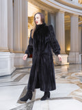 Model in black mink fur coat with structured shoulders and sleek silhouette, styled in a marble hall. Elegant winter fashion, size M.