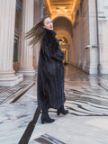 Model twirling in full-length black mink fur coat, showcasing rich texture and movement. Elegant winter outerwear, size M.