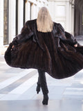 Dark ranch black mink fur coat shown from the back, flared open to reveal its voluminous and plush design, ideal for luxury winter wear.