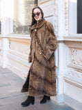 Espresso Mink Long Coat - Regal Swing styled casually against a building, highlighting coat’s length and soft fur texture.