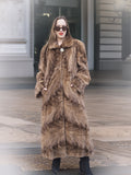 Espresso Mink Long Coat - Regal Swing with hands in pockets, styled with black boots and sunglasses for a chic winter look.