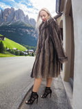 a woman standing on the side of a road wearing a fur coat