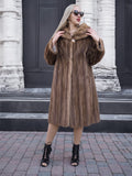 Elegant vintage brown mink fur coat on woman posing in front of building