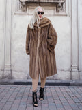 Luxurious vintage Canadian brown mink fur coat, oversized fit, statement accessory for stylish winter looks.