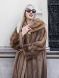Luxurious pastel brown mink fur coat, stylish shades, and bold red lips of a fashionable woman.