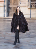 Model in mahogany mink swing coat XL/XXL with soft fur and classic cut. Elegant real fur fashion for cold-weather wear.