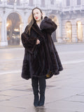 Elegant woman in mahogany mink swing coat XL/XXL with baroque lining detail. Warm and stylish real fur coat for winter fashion.