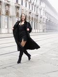 Model in black mink fur coat walking confidently, highlighting the coat’s elegant flow and premium craftsmanship.