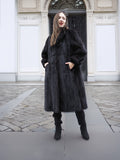 Full-length black mink fur coat with side pockets and structured silhouette, designed for sophisticated cold-weather wear.