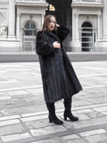 Elegant black mink fur coat with wing collar and plush sleeves, styled for luxury winter fashion and fur outerwear.