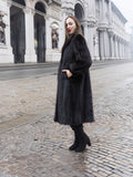 Side profile of woman in dark ranch mink fur coat, showcasing full-length design and premium cold-weather style.