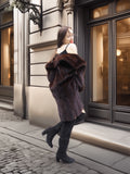Elegant antique mink fur coat draped off-shoulder, showcasing luxurious brown mink texture and classic glamour appeal.