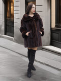 Classic mink coat with wide collar and cuffed sleeves, styled for luxury outerwear in a modern city backdrop.