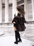 Model spinning in vintage mink coat, showcasing its movement and soft fur texture in a neoclassical architectural space.
