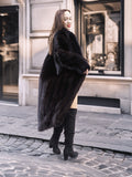 Back view of woman in Midnight Sonata black mink coat, showing off the coat’s voluminous silhouette and rich fur detail.