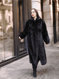 Model walking in full-length Midnight Sonata black mink coat, perfect for cold-weather fashion and luxury outerwear styling.