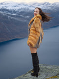 The Wild Muse red gray fox fur coat, styled on a high cliff with sweeping views, perfect for winter fur fashion lovers.