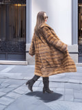Harlow pastel mink shawl collar coat twirling mid-motion, highlighting its full silhouette and rich striped mink texture.