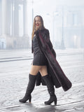 Model walks confidently in red and black mink fur coat and black boots, perfect for luxury winter street style.
