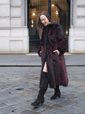 Model walks on wet cobblestone in red and black mink fur coat, ideal for stylish and warm winter outerwear.